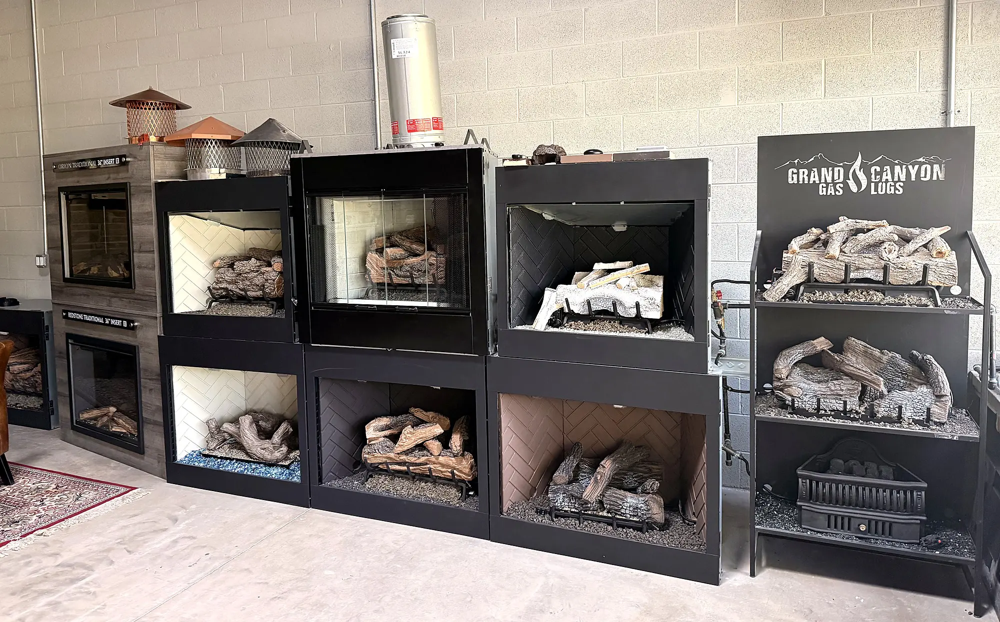 Gas log sets arranged on display stands in the Buffalo Grove display room