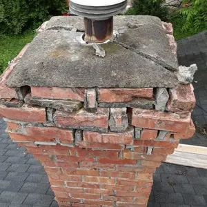 Damaged upper chimney masonry above the roofline in Mundelein before the rebuild