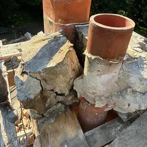 Deteriorated concrete chimney crown and exposed flue tiles before restoration in Tower Lakes, IL