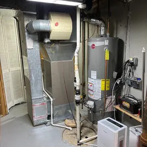 Gas-fired heating equipment and existing vent pipes in a Mundelein mechanical room before utility flue relining