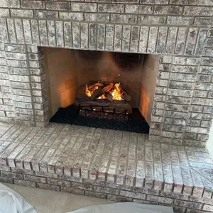24-inch vented natural-gas log set burning inside a brick masonry firebox in Mundelein, IL