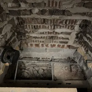 Old refractory brick removed from a fireplace firebox before a full rebuild in Glencoe