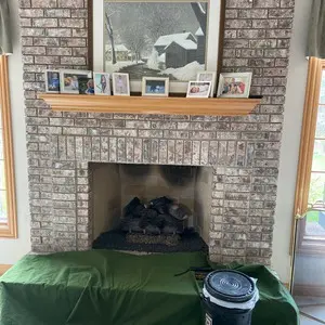 Masonry fireplace in a Mundelein home with the surrounding work area protected before inspection and gas-log installation