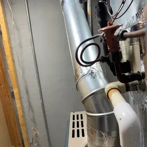 New metal vent connector joining gas heating equipment to a 5-inch stainless-steel utility flue liner
