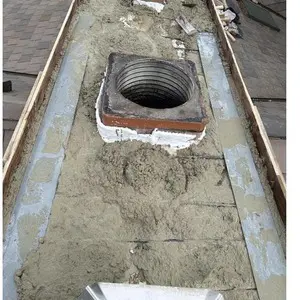 New concrete chimney crown being formed with temporary forms around the flue openings