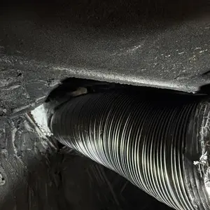 Flexible metal vent liner inside the masonry chimney serving the STUV 6 wood-burning insert