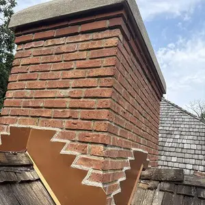 Brick chimney with renewed tuckpointed mortar joints in Tower Lakes, IL