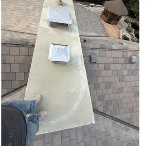 Top view of the finished concrete crown with several vent openings on a stone chimney