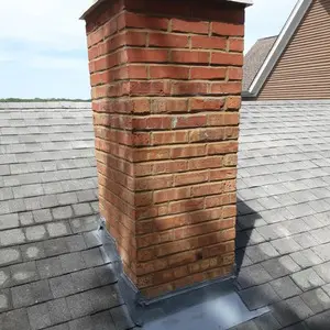 Completed roofline chimney rebuild in Mundelein with new crown and restored brick