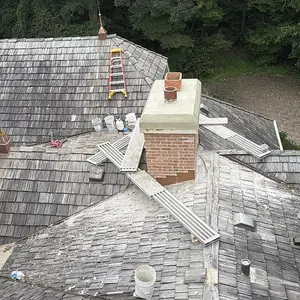 Roof with several masonry chimneys that required safe-access planning in Tower Lakes