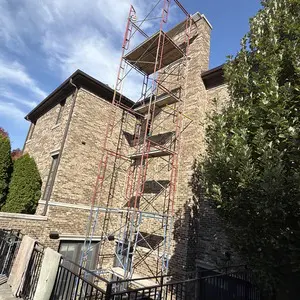 Scaffolding set up around a chimney for safe access during fireplace and liner repairs in Glencoe