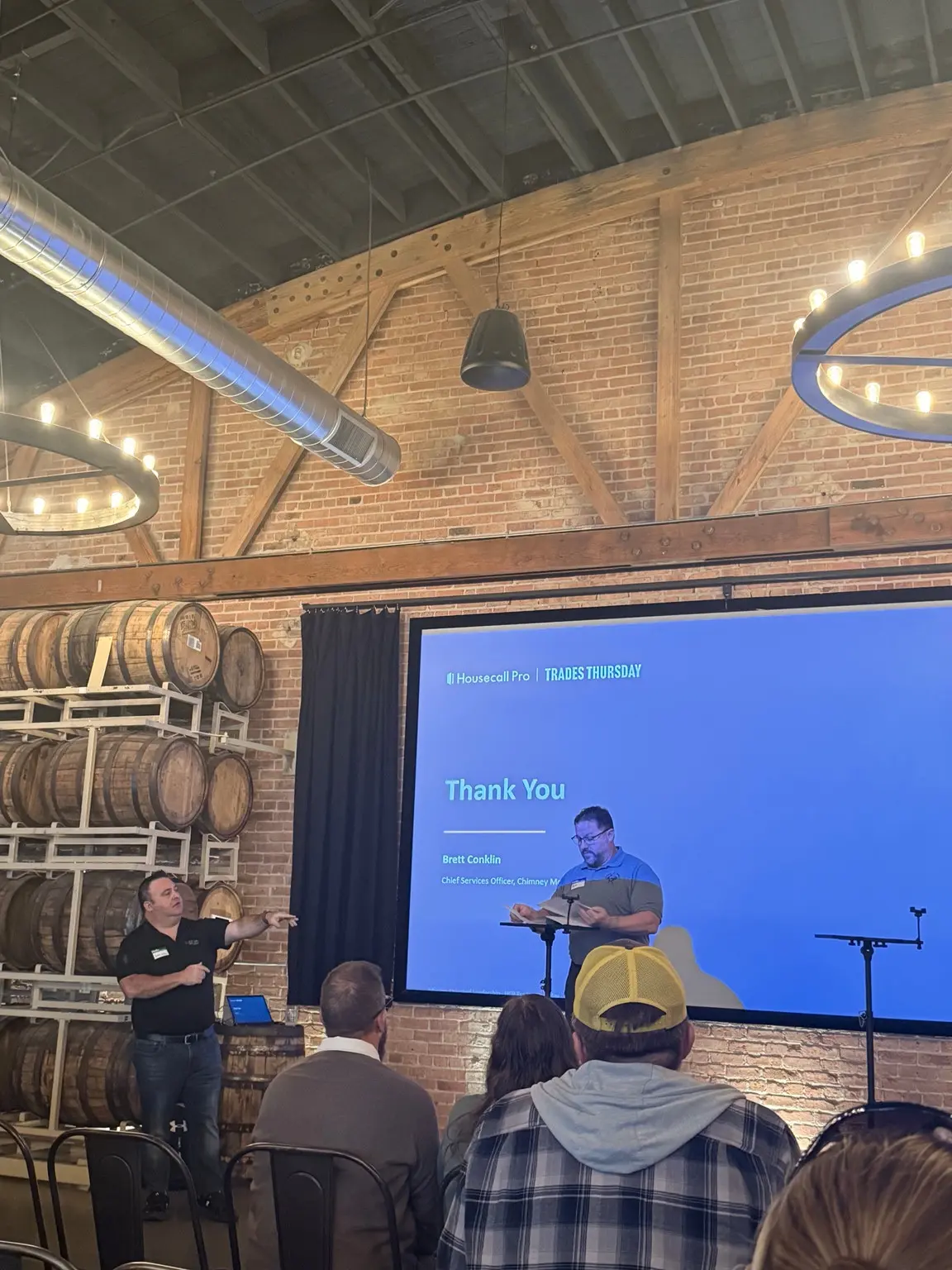 Brett Conklin presenting beside a Housecall Pro Trades Thursday screen at Goose Island Barrel House in Chicago.